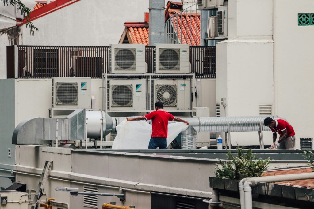 Technicians completing a Daikin AC installation project