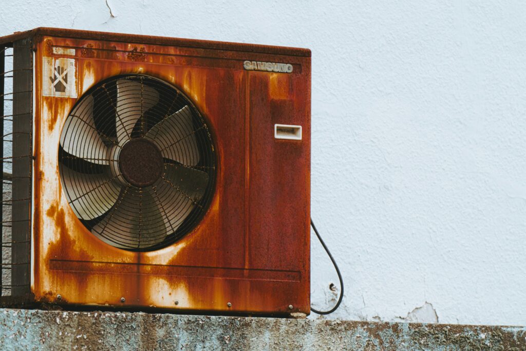 Old worn-out AC unit ready for Daikin replacement in Harlingen, TX